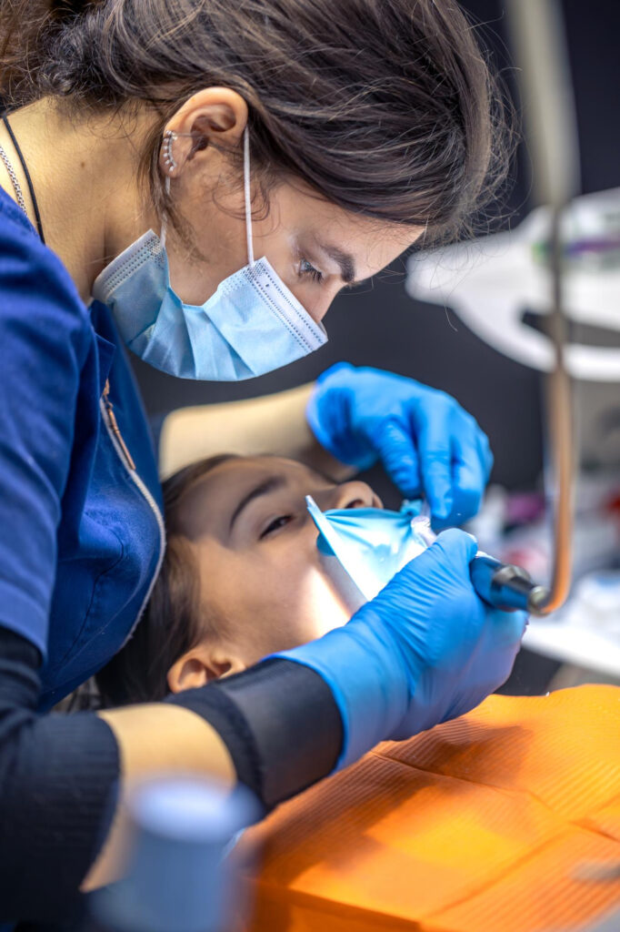 Dentist performing sedation-assisted dental treatment for stress-free care in Denver.