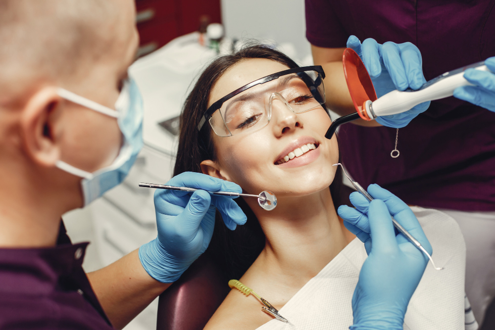 Dentist examining patient’s smile during a Cosmetic Dentistry in Denver visit.