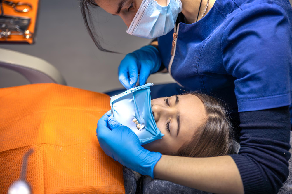 Dental hygienist providing routine cleaning under Preventive Dentistry services.