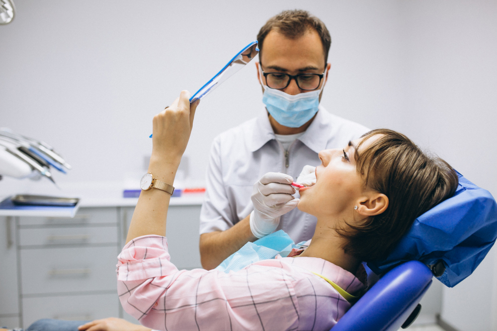Dental professional examining teeth for early issues in Preventive Dentistry care.