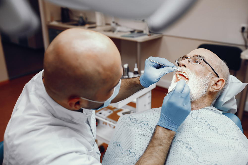 Dentist reviewing X-rays before performing Root Canal Therapy in Denver to ensure accurate treatment.