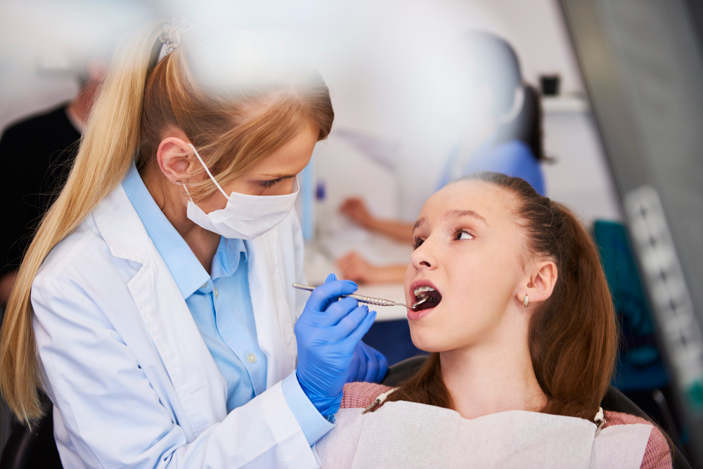Dentist examining a patient’s teeth to prevent cavities and gum disease in Denver.
