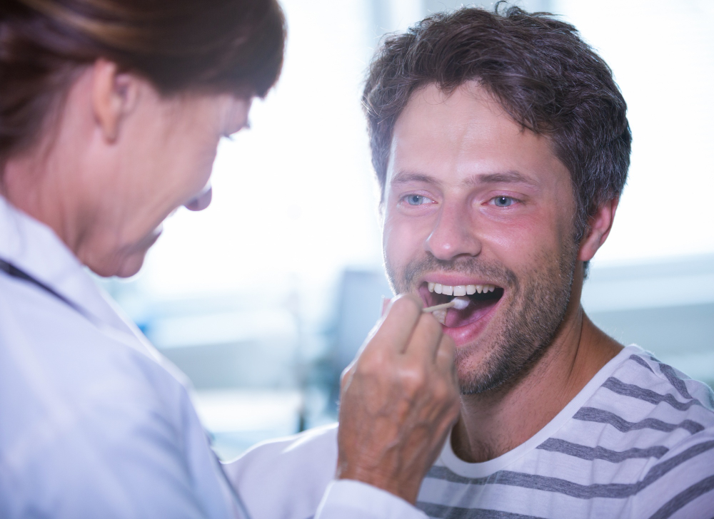 Patient smiling during progress check of full mouth rehabilitation Denver treatment.