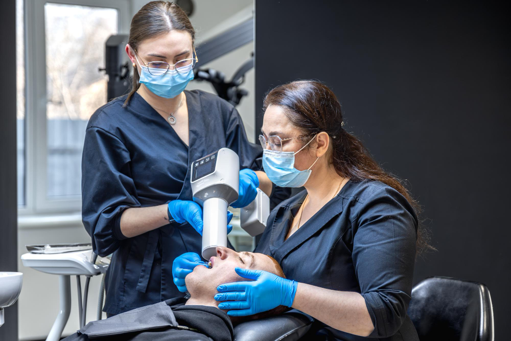 Dentist providing routine checkup and cleaning as part of preventive dentistry care in Denver.