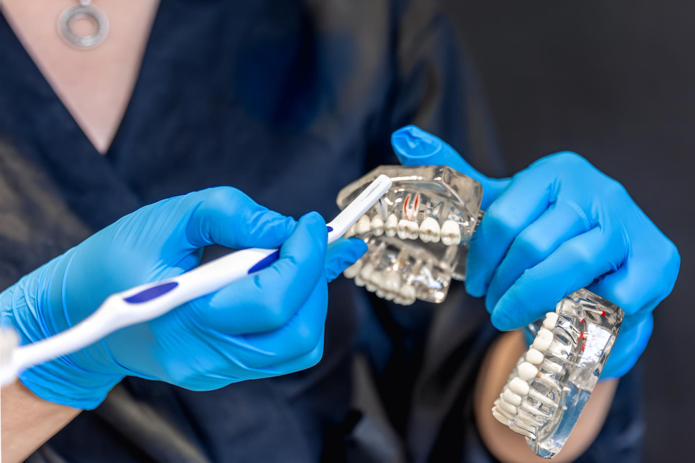 Dentist holding a clear aligner used in oral appliances Denver for teeth alignment.