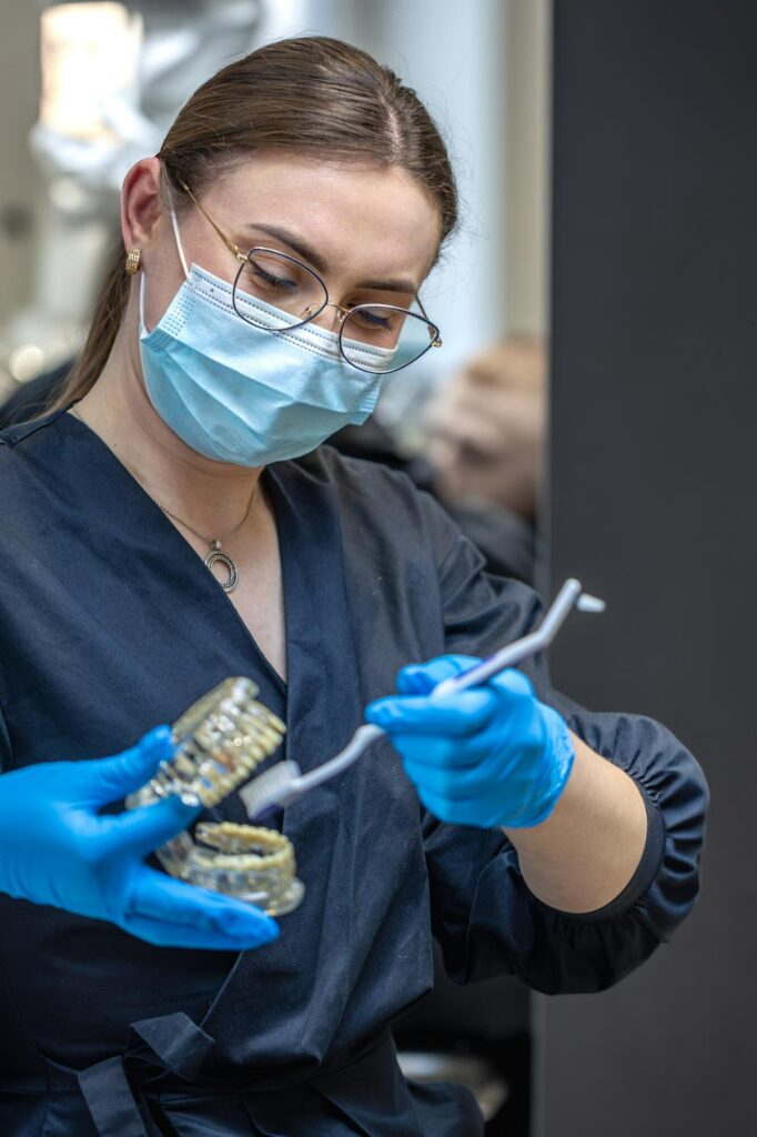 Dental professional preparing a custom oral appliance for patient use in Denver.